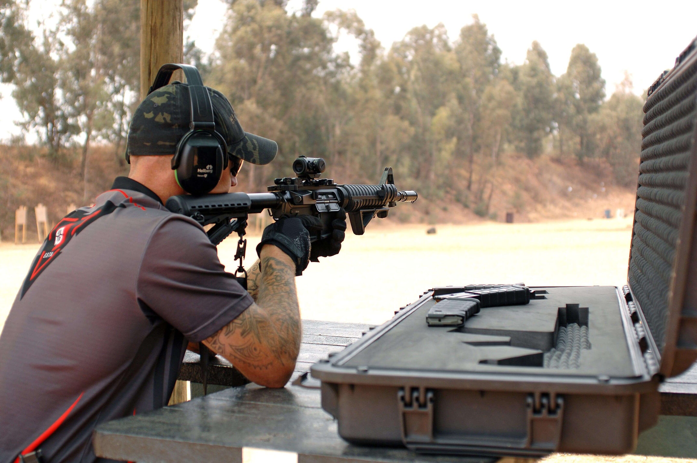 Tactical rifle training at an outdoor shooting range with professional gear