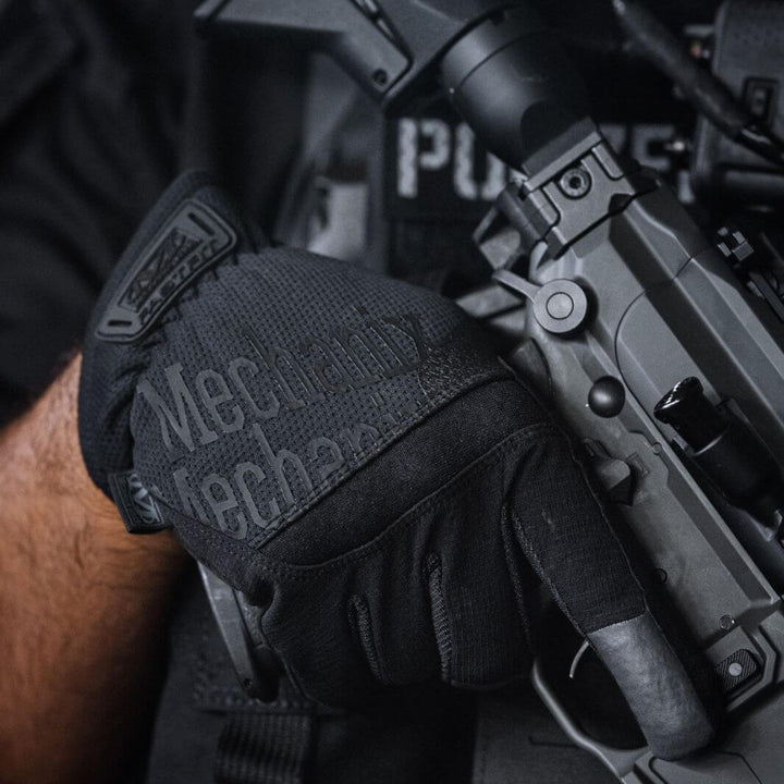 Tactical operator wearing Mechanix Wear FastFit Core3 Covert glove while gripping rifle