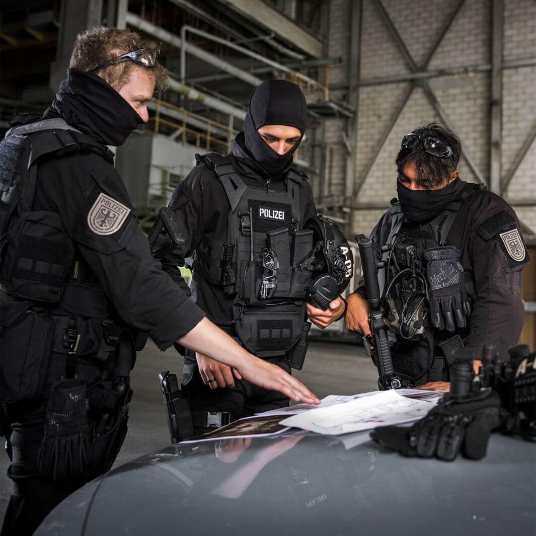 Special forces team using Mechanix Wear FastFit Core3 Covert gloves during tactical briefing