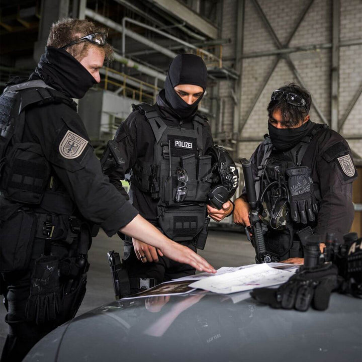 Special forces team using Mechanix Wear FastFit Core3 Covert gloves during tactical briefing