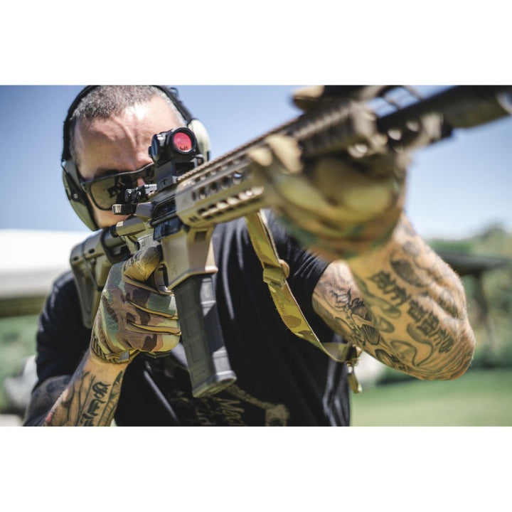 Tactical shooter aiming rifle wearing Mechanix Original Multicam Gloves on shooting range