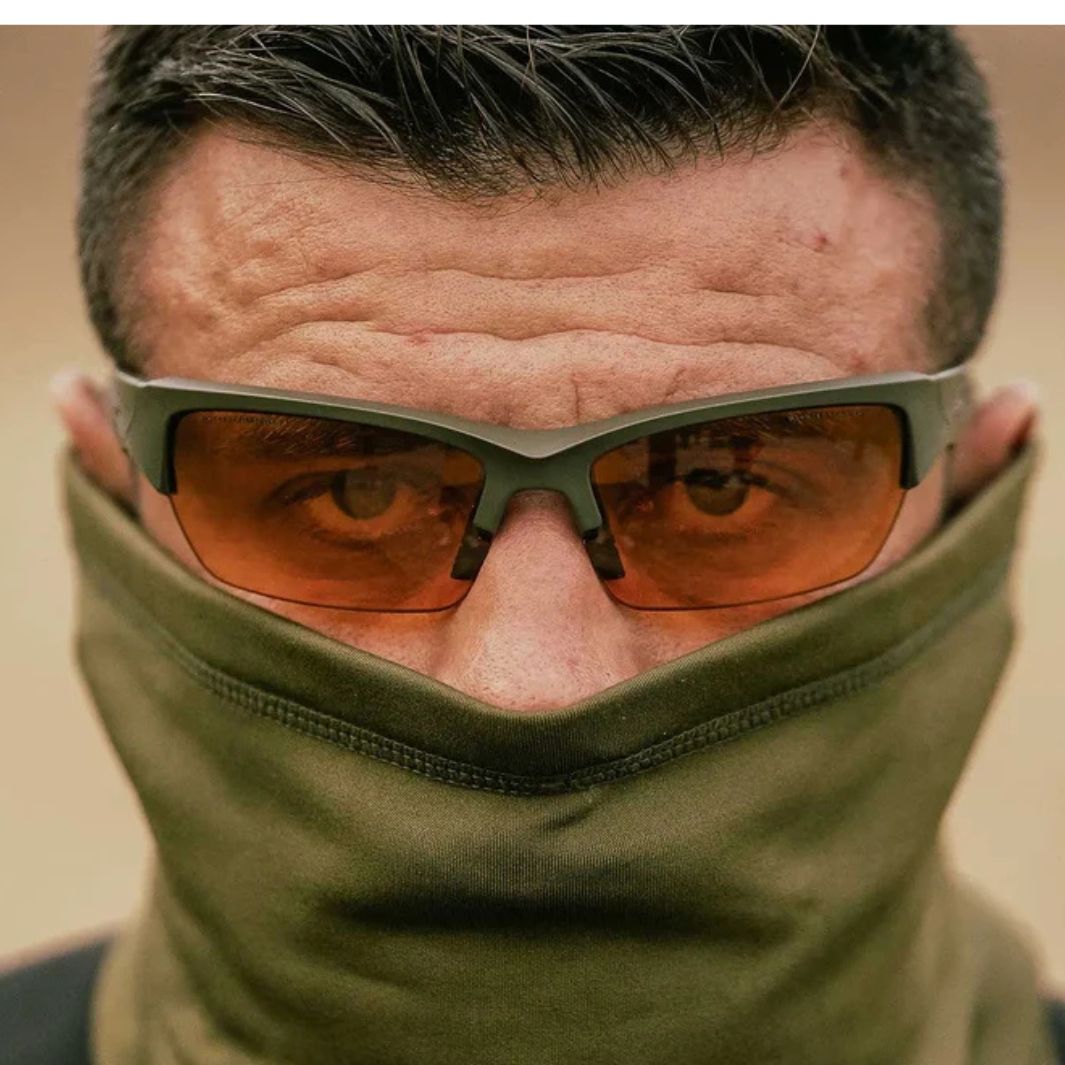 Close-up of Wiley X Valor tactical glasses with Light Rust lenses and Matte OD Green frame worn with a green face covering.